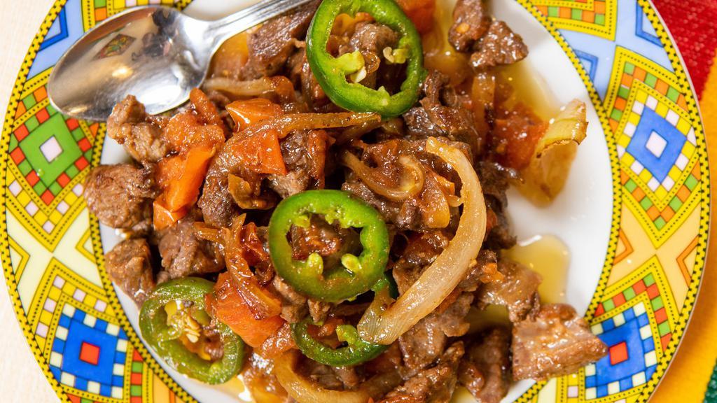 Lega Tibs · Tenderloin beef sauteed with onions, tomatoes, chili peppers, and seasoned with herbed butter.