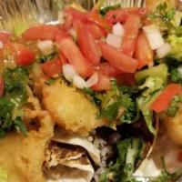 Fish Taco · Fresh tilapia fish battered and deep fried topped up with lettuce, tomatoes, cheese and salsa.