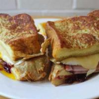 Morning Monte Cristo* · Two fried eggs, Canadian bacon, raspberry preserves,. and cheddar cheese sandwiched between ...