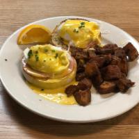 Eggs Benedict* · Two poached eggs on an English muffin with. Canadian bacon topped with hollandaise,. and ser...