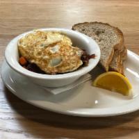Homemade Corned Beef Hash & Eggs* · Made with shredded brisket, potatoes, onions, cabbage, celery, carrots, and garlic. Topped w...