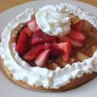 Malted Belgian Waffle · Malted Belgian waffle with your choice of strawberries or bananas. Served with butter and sy...