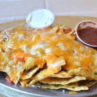 Nachos · Tortilla chips baked with cheddar cheese, fresh jalapeños,. refried beans, and tomatoes