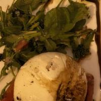 Burrata · Freshly served with tomato confit, basil and finished with balsamic glazed.
