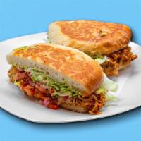Torta · Toasted Mexican telera bread, refried beans, melted Jack cheese, guacamole, pico, lettuce, a...