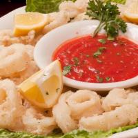 Calamari Fritti · Fresh squid lightly breaded and pan-fried tossed with pepperoncini and served with a lemon c...
