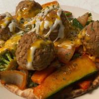 Meatballs On Garden · Meatballs and Grilled Vegetables topped with melted Mozzarella and Cheddar cheese, served on...