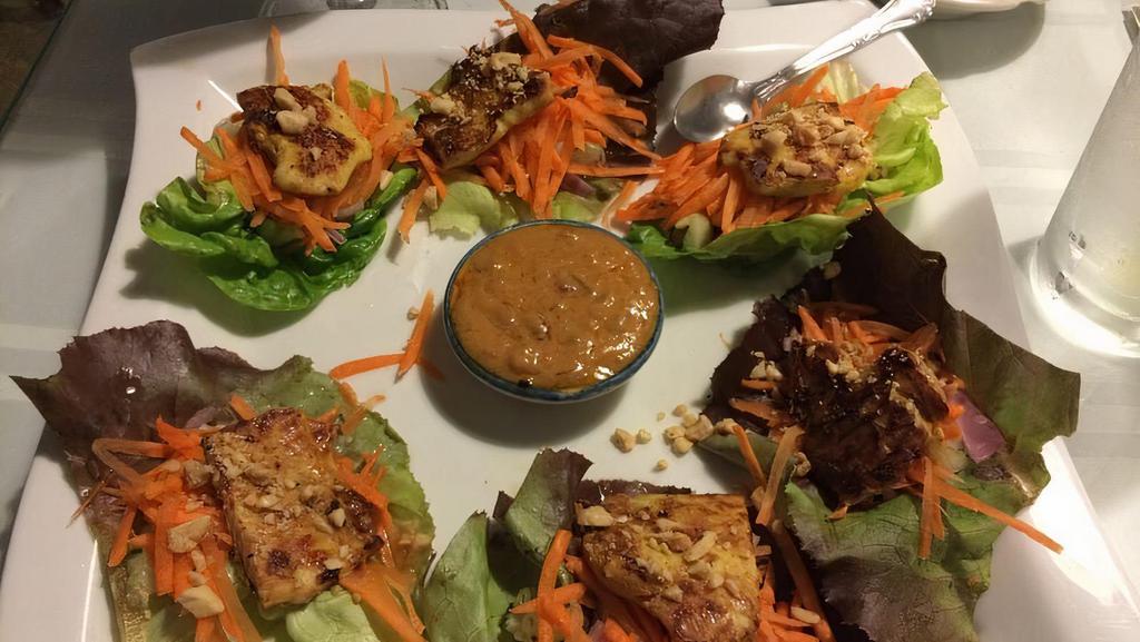 Thai Lettuce Wrap · Grilled marinated chicken, carrot, marinated cucumber and onion, sprout, cilantro and crushed peanut on Boston lettuce, served with peanut sauce.