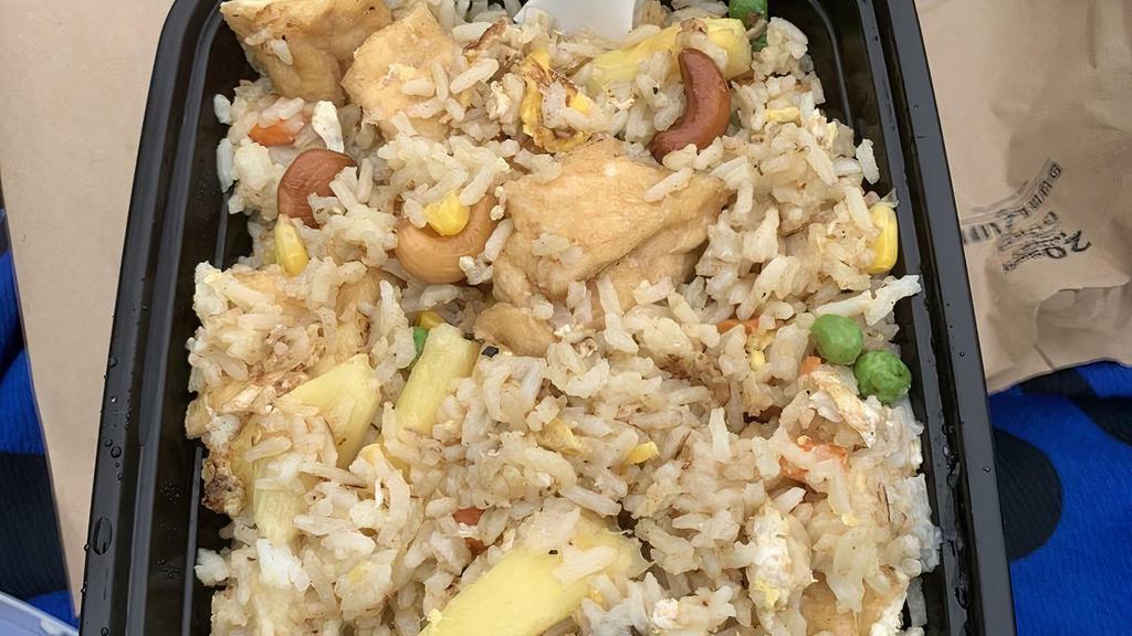 Pineapple Fried Rice · Kow pad sub pa rob. Pan-fried rice with your choice of meat, egg, pineapples, curry powder, scallions, cashew nuts, carrots, raisins, and sweet peas.