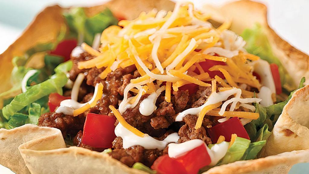 Taco Salad · Comes in a baked flour tortilla or with chips. Included are lettuce, cheese, tomatoes, sour cream, guacamole and black olives. Your choice of meat, salsa and beans.