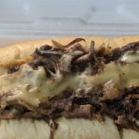 Township Line Brisket Cheese Steak · Shredded beef brisket smothered in our house cheese sauce. Topped with caramelized onions an...