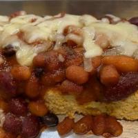 Loaded Cornbread · 2 Pieces of house made cornbread  topped w/ delicious beaked beans, and smothered in cheese