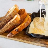 Queso Fundido · Mexican Cheese fondue, garlic toast.