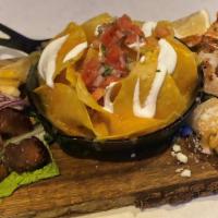 3 Amigos Platter · Cheese nachos, Chicken taquitos, yuca con chicharron, and grilled shrimp.