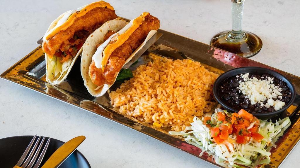 Fish Tacos · Crispy battered cod, pickled cabbage, pico de gallo, lemon garlic, chipotle aioli, flour tortilla.. Served with rice and beans.