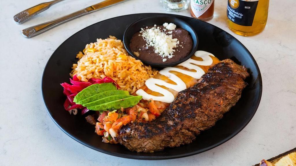 Carne Asada · Grilled marinated steak, cheese  enchilada, avocado, rice and refried beans.