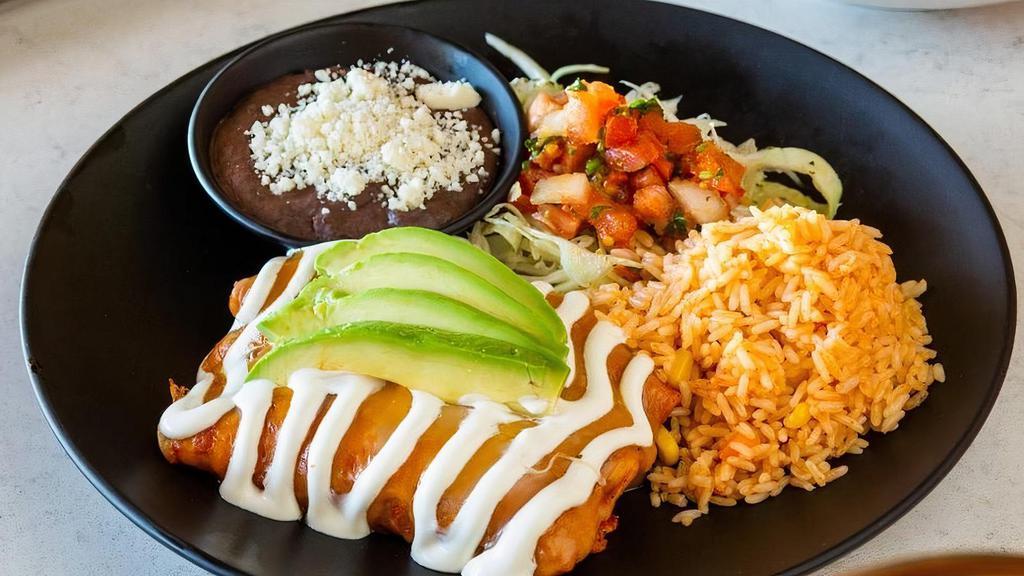 Shrimp Enchilada · Corn tortilla, grilled shrimp, enchilada sauce, melted cheese, pico, gallo, crema fresca, avocado. Served with refried beans, and Mexican rice.
