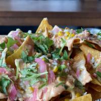 Nachos: Crab And Street Corn  · Crabmeat, garlic butter corn, pickled red onion, chipotle lime crema, our famous cheese sauc...