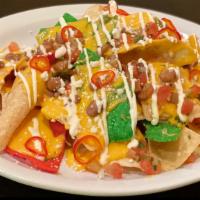 Loaded Nachos · Housemade Chip, melted queso, Pico de Gallo, pinto beans, sour cream , scallions, and pickle...