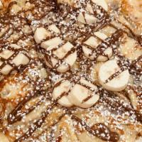 Nutella Banana Crepes
 · Topped with powdered sugar and whipped cream