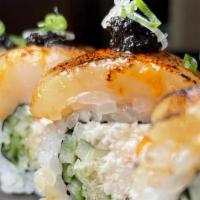 Ocean Maki · imitation crab,snow crabmeat,cucumber,tempura flakes,topped with torcheds callops,spicy mayo...