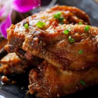 Crispy Chicken Wings · Spicy or with garlic sauce.