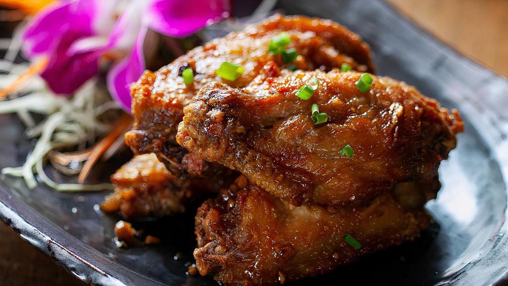 Crispy Chicken Wings · Spicy or with garlic sauce.