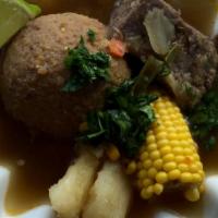 Caldo De Bola · Caldo de bola de verde con un porcion de arroz
Green plantain & beef soup