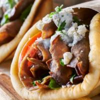 Lamb Gyro · Served with toppings and tzatziki sauce.