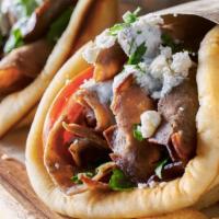 Beef Gyro · Served with toppings and tzatziki sauce.