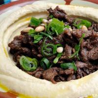 Hummus With Gyro Meat · Hummus topped with gyro choice of meat (lamb, beef, chicken) served with pita bread.