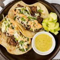 Korean Bbq Taco · Korean style tacos with choice of meat, scallions, onions and lettuce served with social Kor...