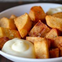 Patatas Bravas · Vegetarian. Fried potatoes, aioli, spicy tomato sauce.