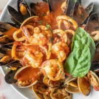 Seafood Combo · Scampi or red sautéed mussels clams, shrimp and calamari with garlic in a zesty marinara. Se...