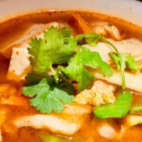 Tom Yum Soup · A signature Thai soup, the broth is flavored with lemongrass, mushrooms, tomatoes and your c...
