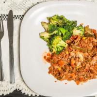 Salmon Fried Rice Bowl · Vegetable Fried Rice topped with 6oz of Salmon served with steamed broccoli in a garlic butt...