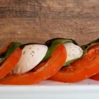Caprese Salad · Buffalo mozzarella, vine-ripened tomatoes, EVOO, and balsamic glaze.
