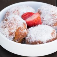 Nutella Doughnuts · 4 nutella stuffed doughnuts, tossed in sugar and topped with fresh strawberries