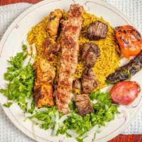 Mix Grill Plate · Three skewers of kebab, shish tawook and lamb kebab served with rice and grilled vegetables.
