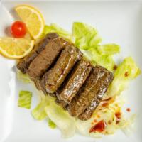 Grape Leaves · Stuffed grape vine leaves with rice, tomatoes, onions, chopped parsley with pomegranate mola...