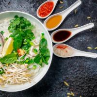Phở Gà Đặt Biệt · Pho chicken soup with combination of white and dark chicken meat.