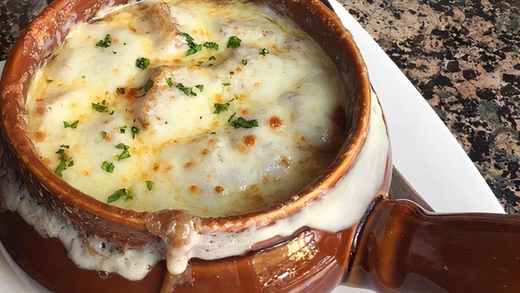 French Onion Soup · Sweet onions and crostini, under a blanket of perfectly melted gruyere cheese.