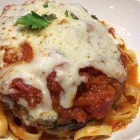 Eggplant Parmesan · Breaded eggplant topped with tomato sauce, mozzarella, and parmesan cheeses. Served over pas...