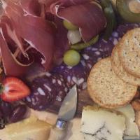 Plateaux Delice · Assortment of salami, cured meat, and three cheeses. Served with mustard, cornichons, marina...