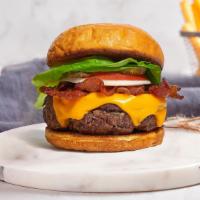 Never Been Bacon Burger · American beef patty topped with melted cheese, layers of crispy bacon, lettuce, tomato, onio...