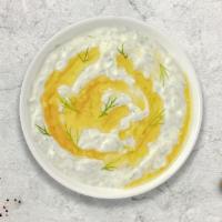 Tzatziki · Salted strained yogurt with diced cucumbers, garlic, salt, olive oil, lemon juice, and herbs
