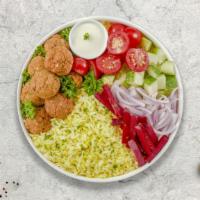 Falling For Falafel Rice Bowl · Falafel balls topped with house sauce, white sauce, parsley and onions served with yellow ri...