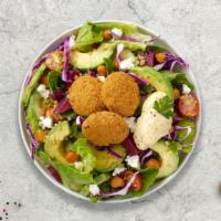 Falafel On A Garden Salad · Arabic salad with three pieces of falafel served with Tahini sauce.