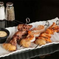 Garlic Skewers · Marinated shrimp, chicken and beef served with fingering potatoes.