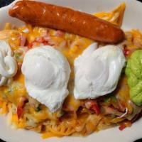 Huevos Rancheros · Two pouched eggs on top of  bed made out of corn tortilla chips layered with our very own Sa...